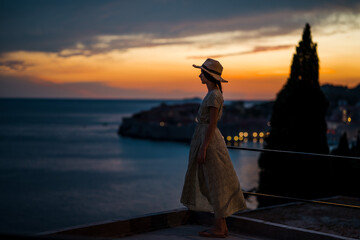 Beautiful female model on the streets of old town dubrovnik. Beautiful sunset.
