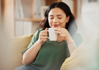 Tea, relax and smile with a woman in her home, sitting on a sofa in the living room enjoying a beverage. Peace, quiet and eyes closed with a happy young female person drinking coffee in her house