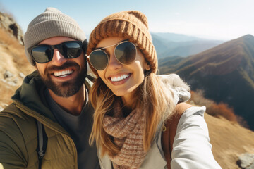 Selfie photo of happy smiling young couple during traveling together at beautiful destination in the mountains
