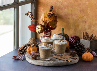 Homemade pumpkin spice latte chia puddings on a rustic wooden board.