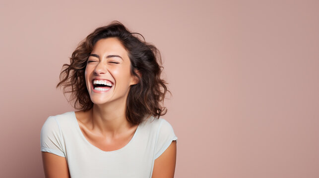 laughing woman close up, simple backdrop