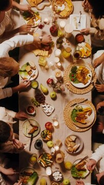 Top view of a beautifully laid festive table. Guests eat and talk while sitting at the table outdoor