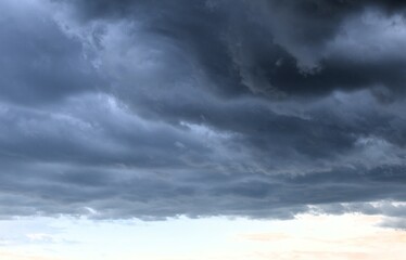 Naklejka na ściany i meble dark gray storm clouds in the sky