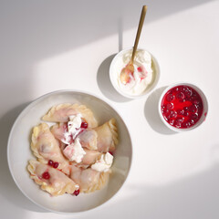 Іти на сторінку
|12345Далі
White bowl with testy fresh varenyki with berries and sour cream in daylight