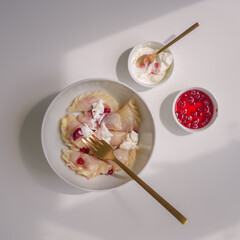 bowl of fresh varenyki with yogurt and jam