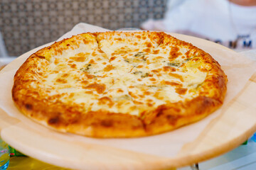 Appetizing cheese pizza. A dish of Italian cuisine.