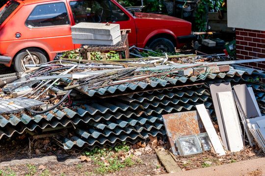 mess in the garden, old abandoned car, piles of garbage, environmental concept
