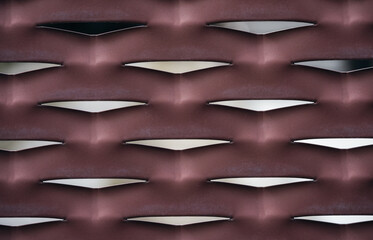 Abstract modern metallic mesh texture pattern for background. Perforated fence in dark red tones.