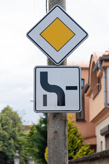 Road sign main road. Traffic sign priority road. Additional sign to the sign indicates the direction of the main road.