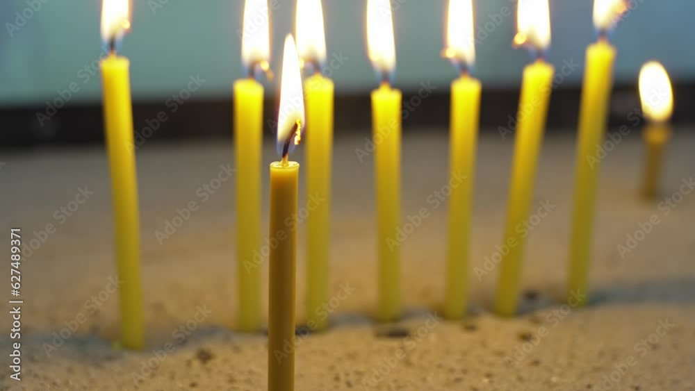 Wall mural Candles set in the sand in the church