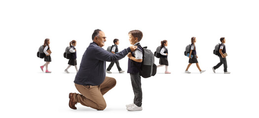Grnadfather helping a boy getting ready for school and other children walking in the back