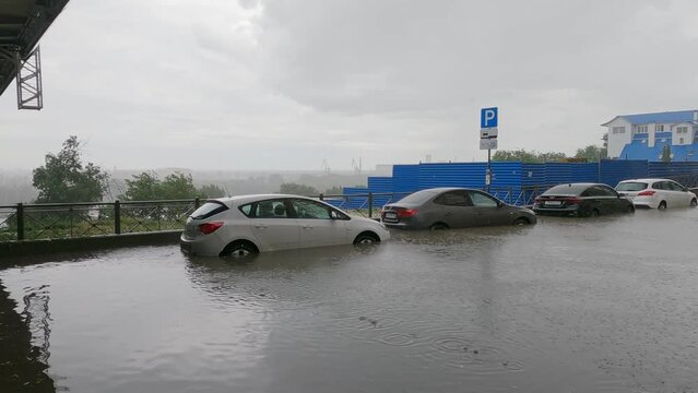 city roads and cars flooded in the rain. malfunction of storm sewers in the city