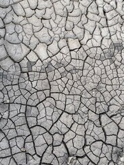 Cracked black dry dirt texture. Natural background