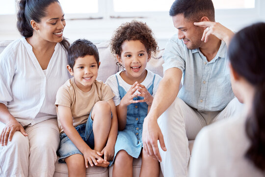 Parents, kids and counselling with psychology, smile and together on sofa, support and discussion. Young family, children and happy on couch with psychologist, listening and talking for mental health