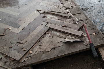 A closeup of an old broken dismantled parquet floor