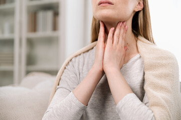 Cropped view of woman hands touching lymph nodes on throat - obrazy, fototapety, plakaty