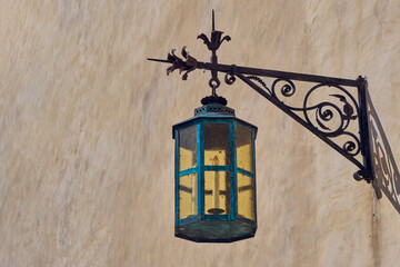 Fototapeta na wymiar Vintage forged street lamp on wall