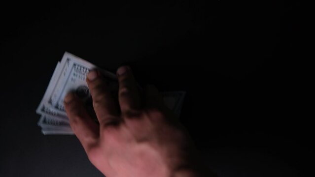 Unrecognizable Person Buying Drug from the Dealer. Bad Habits. Narcotic Concept on Black Background. Junkie Gives Money to Dealer and Gets White Drug. High Angle View of Addict and Seller Hands 4K.