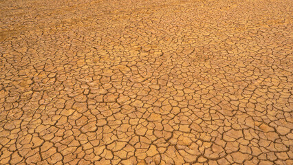 AERIAL: Pattern of cracks on a desolate desert landscape due to lack of rain