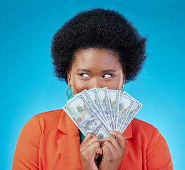 Cash, hide and a black woman lottery winner on a blue background in studio holding money for finance. Savings, investment or economy growth with a young female person excited for financial freedom