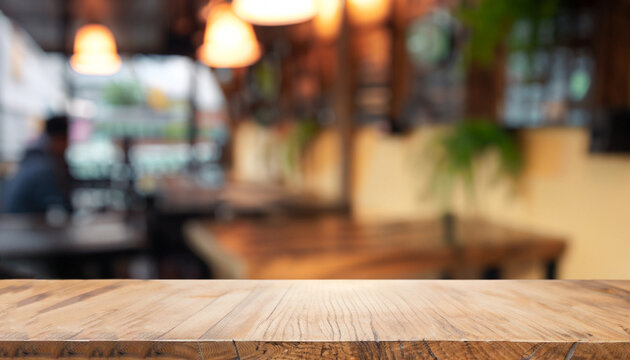 The empty wooden table top with blur background of cafe. Exuberant image.
