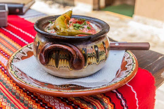 Typical dish of Bulgaria - Gyuveche. Meal baked in a clay pot.