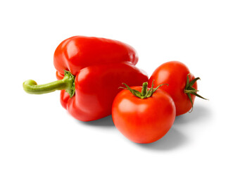 Red bell pepper and tomatoes isolated on white background, close-up.