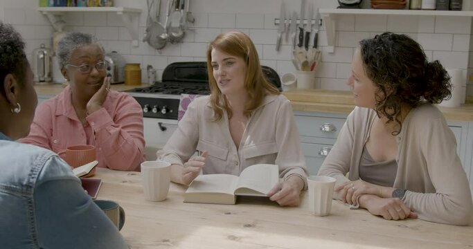 Group of Female Friends Book club Discussing at Kitchen Table