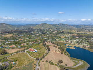 Fototapeta premium Aerial view over water reservoir and a large dam that holds water. Rancho Santa Fe in San Diego, California, USA