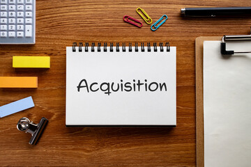 There is notebook with the word Acquisition. It is as an eye-catching image.