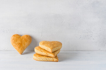 Shortbread cookies in the shape of a heart on a light blue background. cookie day