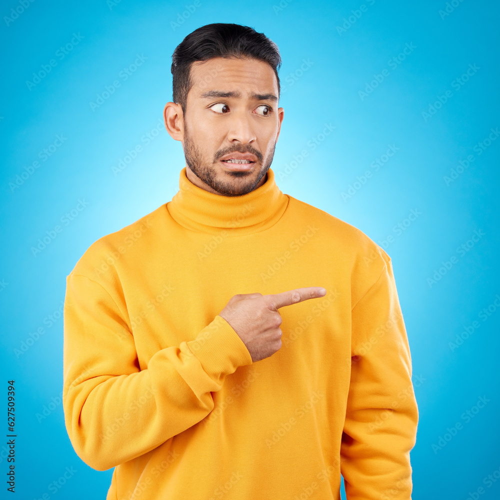 Poster Wtf, surprise and asian man hand pointing in studio for menu, questions and how to steps on blue background. Omg, doubt and male face with finger show feedback, schedule or presentation with anxiety