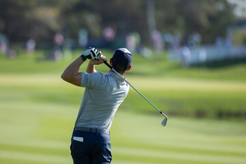 professional golf player hitting the ball. backswing