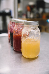 large canning jars of jam jelly in an industrial kitchen