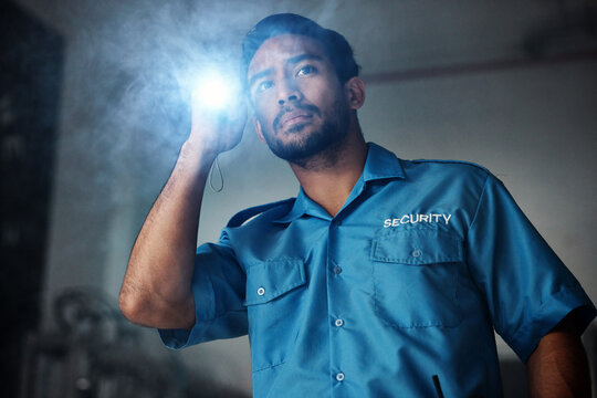 Torch, security and man at night for investigation, inspection or property search in dark room. Surveillance, law and police male person with flashlight for safety, crime guard and protection service