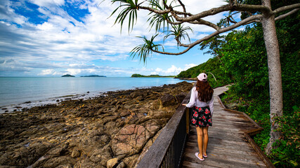 pretty girl enjoys a sunny day at south mission beach in tropical north queensland  relaxing at the beach in australia © Lens Down Under