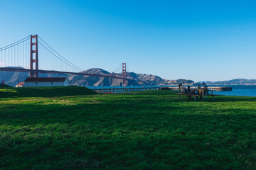 friends having a picnic in front of the golden gate in a park