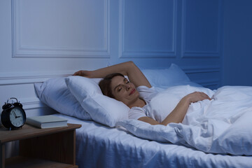 Fototapeta Beautiful woman sleeping in bed at night obraz