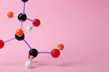 Molecule of sugar on pink background, closeup with space for text. Chemical model