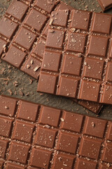 Tasty chocolate bars on wooden table, flat lay