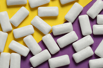 Tasty white chewing gums on color background, flat lay