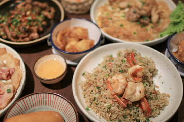 Fried rice with shrimp on white plate. Quick and healthy Asian meal. Made from fresh shrimps, lime and vegetables.