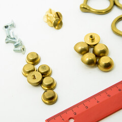 A collection of metal fittings used for leather products
