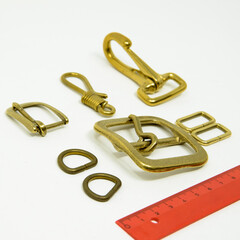 A collection of metal fittings used for leather products