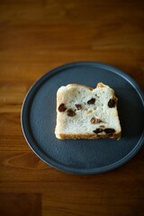 黒い皿に乗せたレーズン食パン