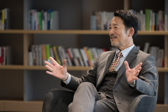 Image of a handsome president, professor, or other important person smiling and giving an interview, etc. Close-up