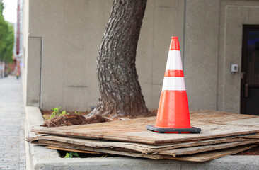 Vibrant construction cone amidst urban chaos signifies progress, safety, roadwork, caution, and...