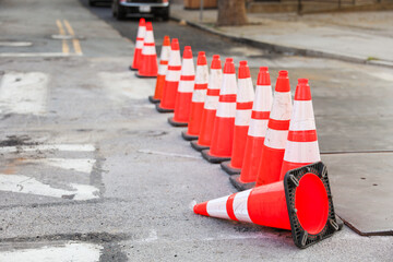 Vibrant construction cone amidst urban chaos signifies progress, safety, roadwork, caution, and...