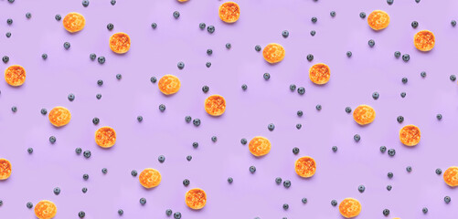 Many cottage cheese pancakes and blueberry on color background. Pattern for design