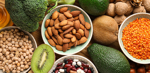 Healthy products rich in vitamin E on table, top view
